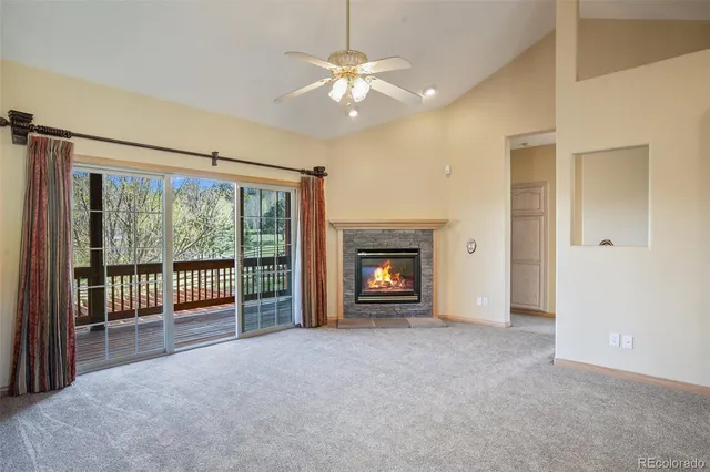 wooden floor fireplace and windows in an empty room