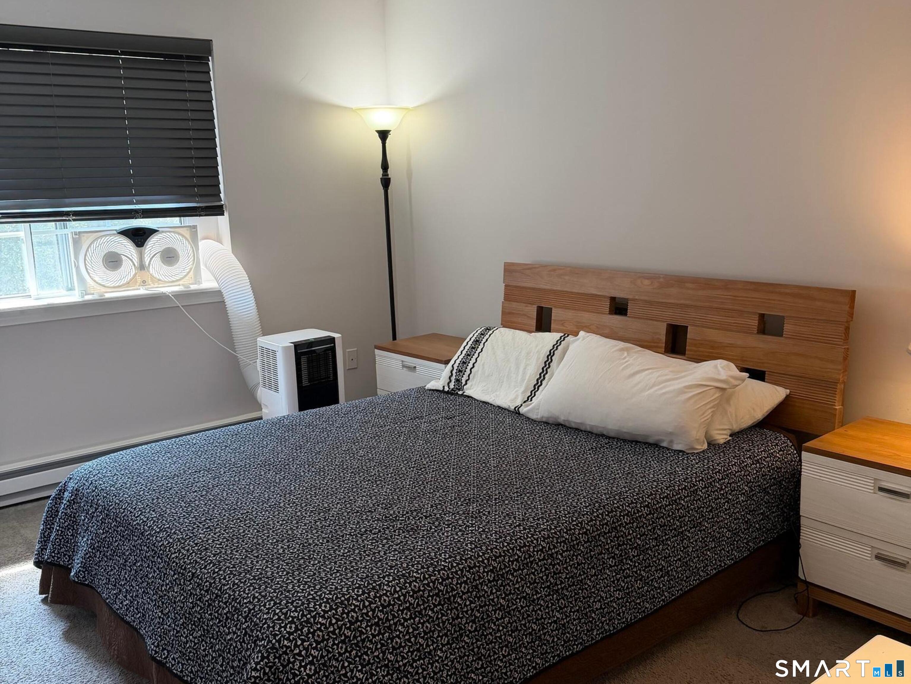 21 Lisa Court, Unit 10 Waterbury, CT 06704 - Photo 10 of 14 a bedroom with a bed and two night stand