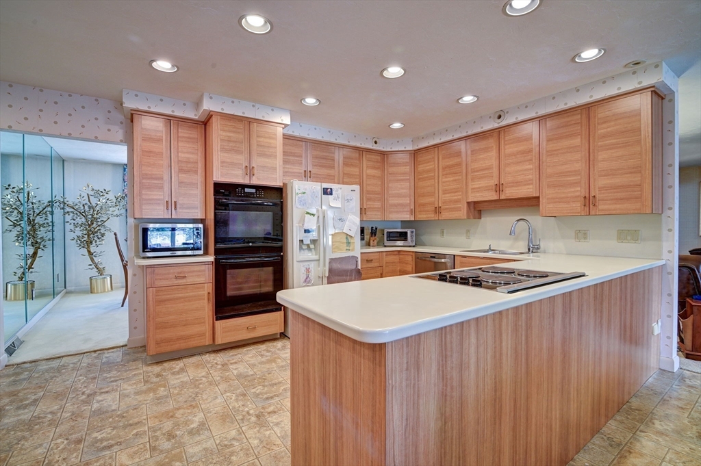 14 Seneca Road Canton, MA 02021 - Photo 12 of 42 a kitchen with stainless steel appliances granite countertop a refrigerator a stove and a sink