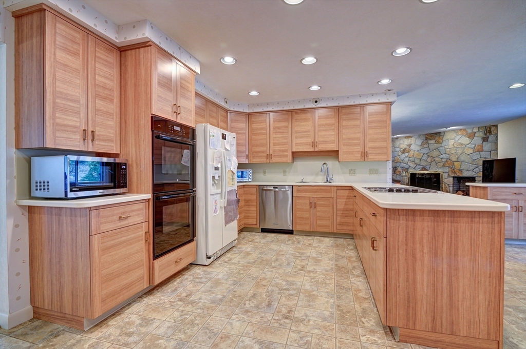 14 Seneca Road Canton, MA 02021 - Photo 13 of 42 a kitchen with stainless steel appliances granite countertop a stove refrigerator sink and cabinets