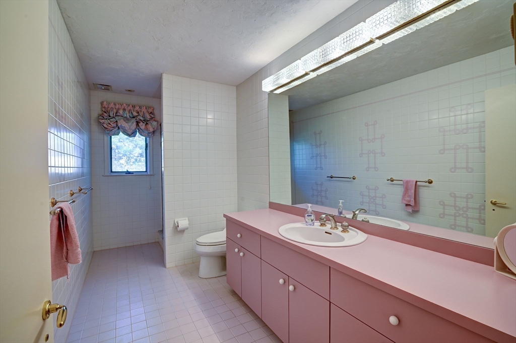 14 Seneca Road Canton, MA 02021 - Photo 26 of 42 a bathroom with a double vanity sink toilet and a mirror