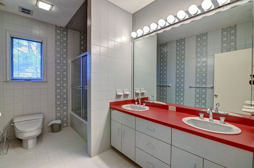 14 Seneca Road Canton, MA 02021 - Photo 31 of 42 a bathroom with a double vanity sink toilet and a mirror