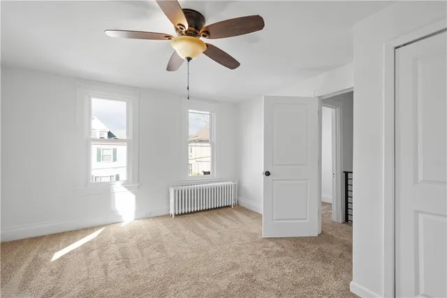 a view of a livingroom with a ceiling fan and window