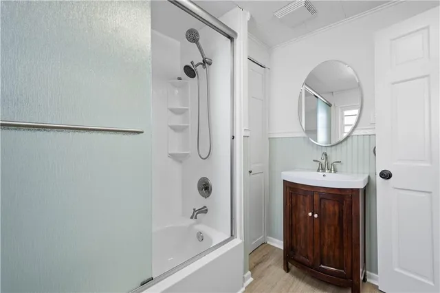 a bathroom with a sink a mirror and a shower