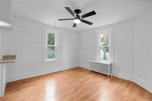 wooden floor in an empty room with a window