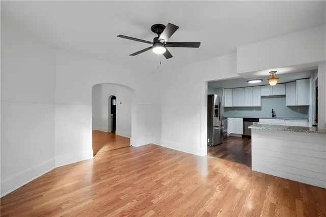 a view of kitchen and living room with wooden floor