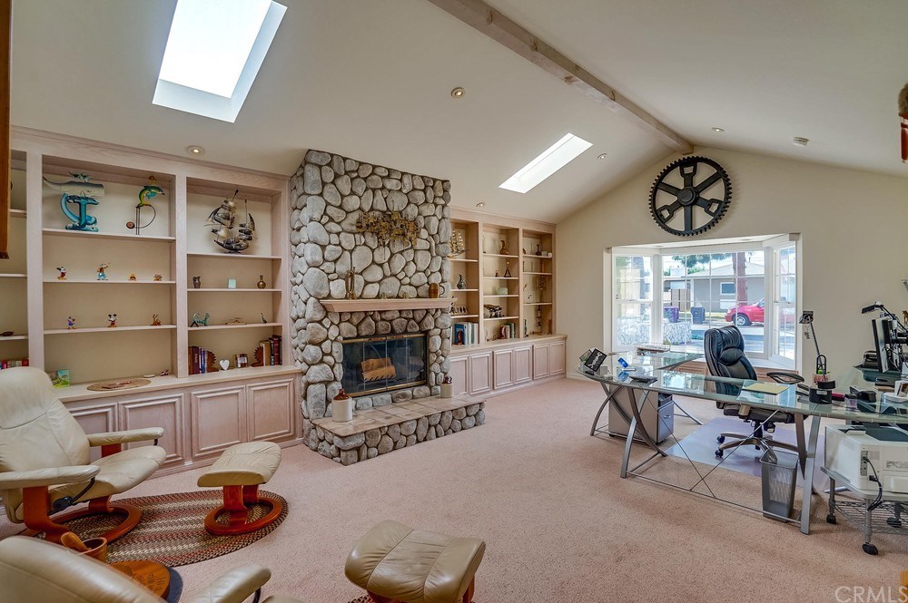 460 Peralta Avenue Long Beach, CA 90803 - Photo 6 of 42 The living room is large and bright! They're using it as an office, but it could be an amazing gathering space for friends and family!