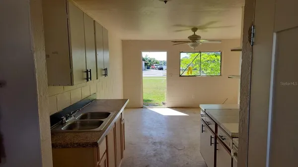 a kitchen that has a stove and a window