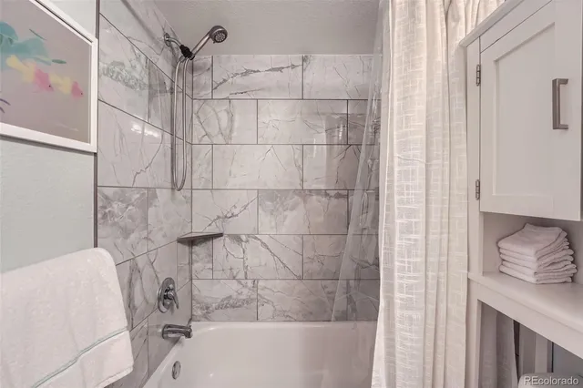 a bathroom with a bathtub and shower