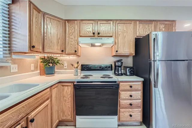 a kitchen with a refrigerator and a sink