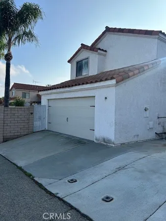 a view of a white house with a yard