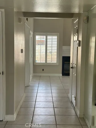 a view of a hallway with wooden shelves