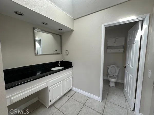 a kitchen with a refrigerator and a sink