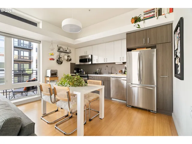 a kitchen with stainless steel appliances granite countertop white cabinets a sink and dishwasher