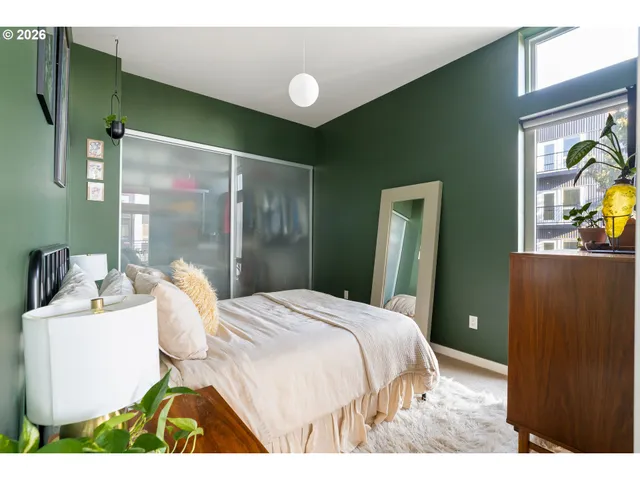 a bedroom with a bed lamps and a fireplace