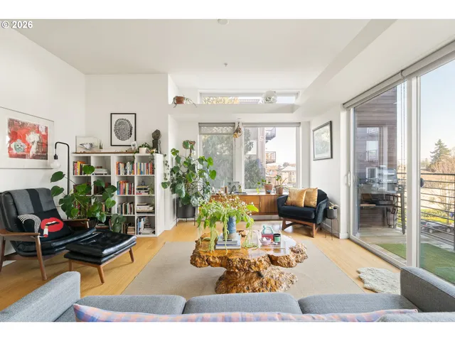 a living room with furniture and a potted plant