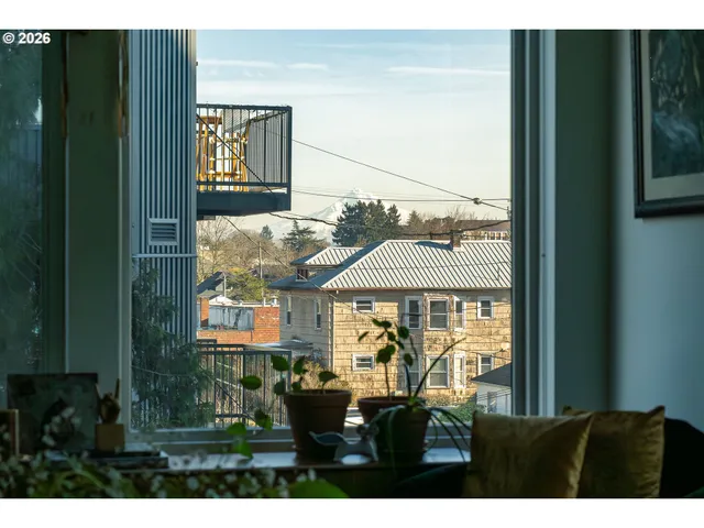 a living room with furniture and a open kitchen view