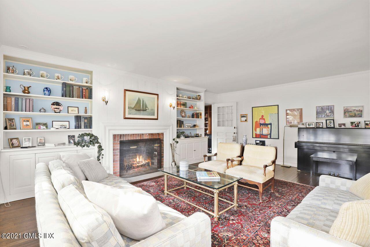90 Winthrop Drive Riverside, CT 06878 - Photo 5 of 27 a living room with furniture a fireplace and a book shelf