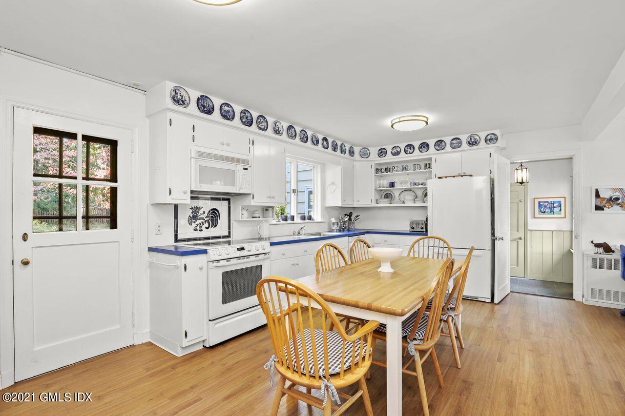 90 Winthrop Drive Riverside, CT 06878 - Photo 8 of 27 a kitchen with stainless steel appliances granite countertop a refrigerator a stove a sink dishwasher and white cabinets with wooden floor