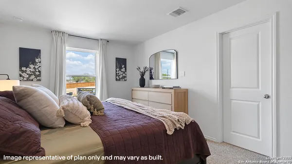 a bedroom with a large bed and a couch