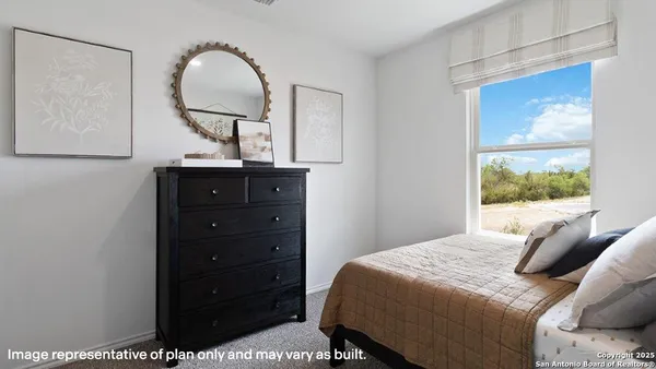 a bedroom with a bed and a mirror