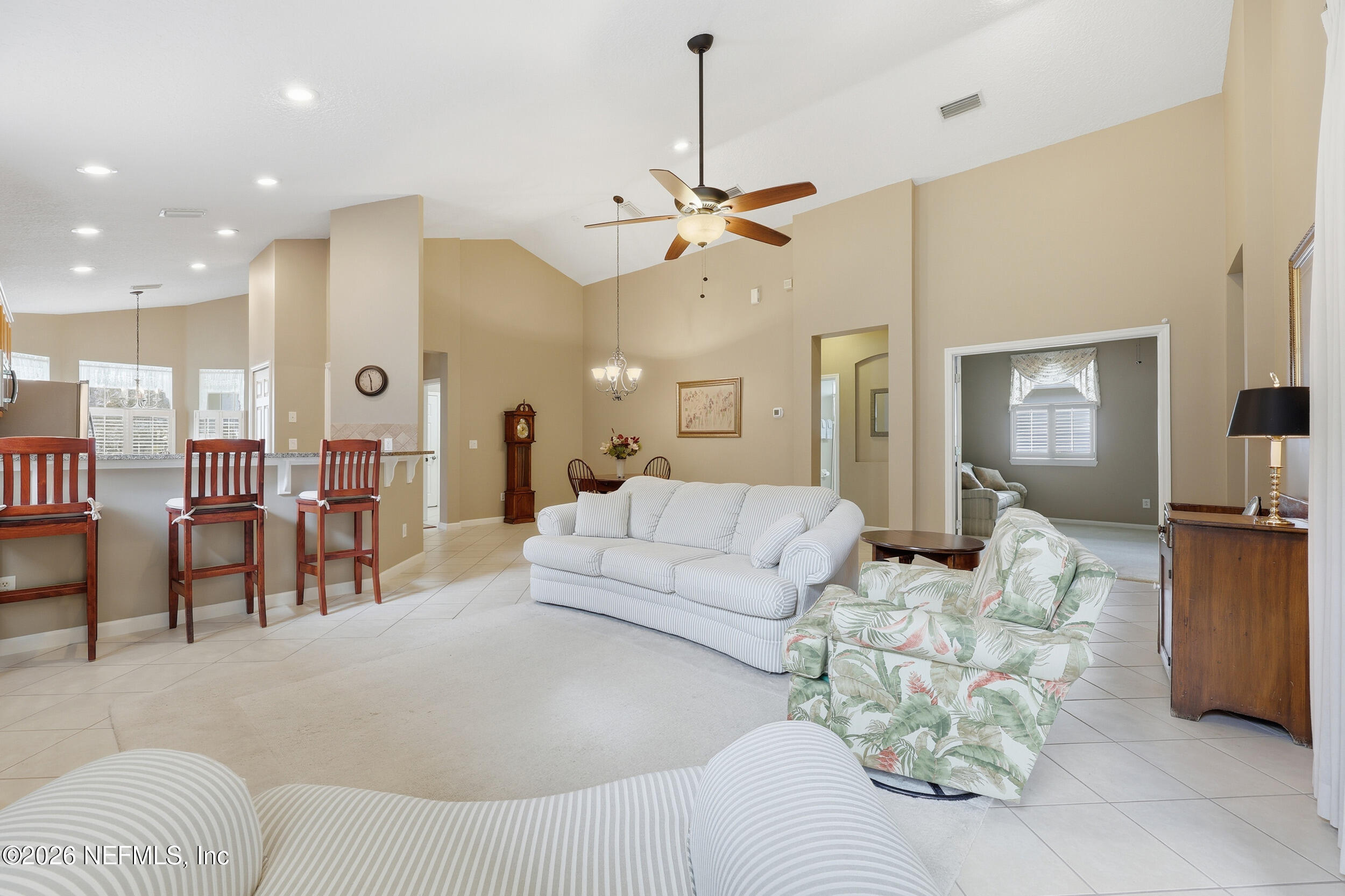 720 Copperhead Circle St. Augustine, FL 32092 - Photo 65 of 65 a living room with furniture kitchen view and a chandelier