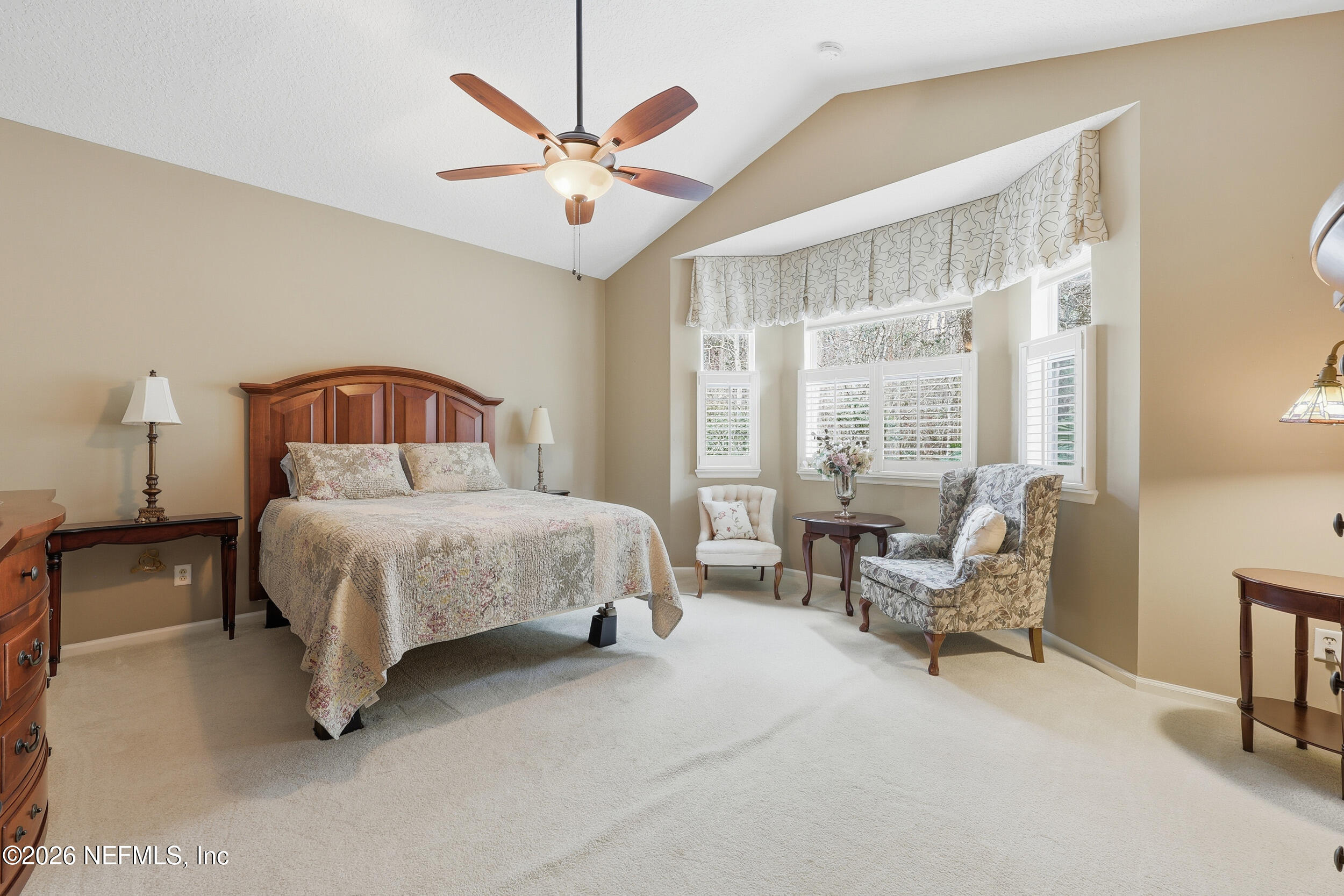 720 Copperhead Circle St. Augustine, FL 32092 - Photo 17 of 65 a bedroom with a large bed a flat screen tv and a large window