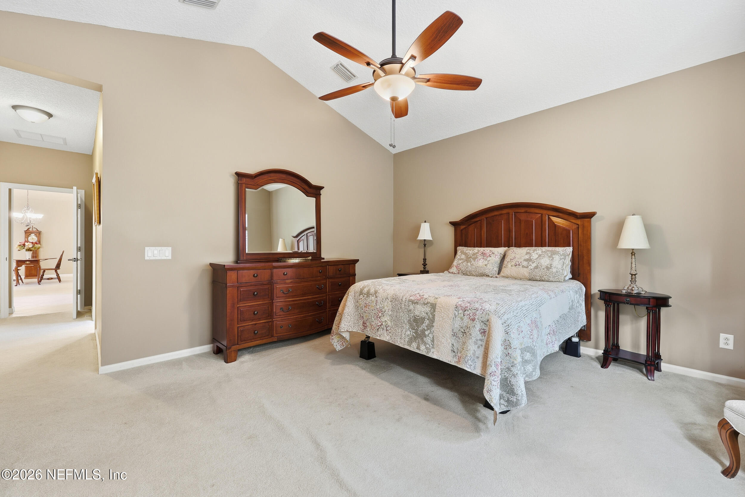 720 Copperhead Circle St. Augustine, FL 32092 - Photo 18 of 65 a bedroom with a bed and a chandelier