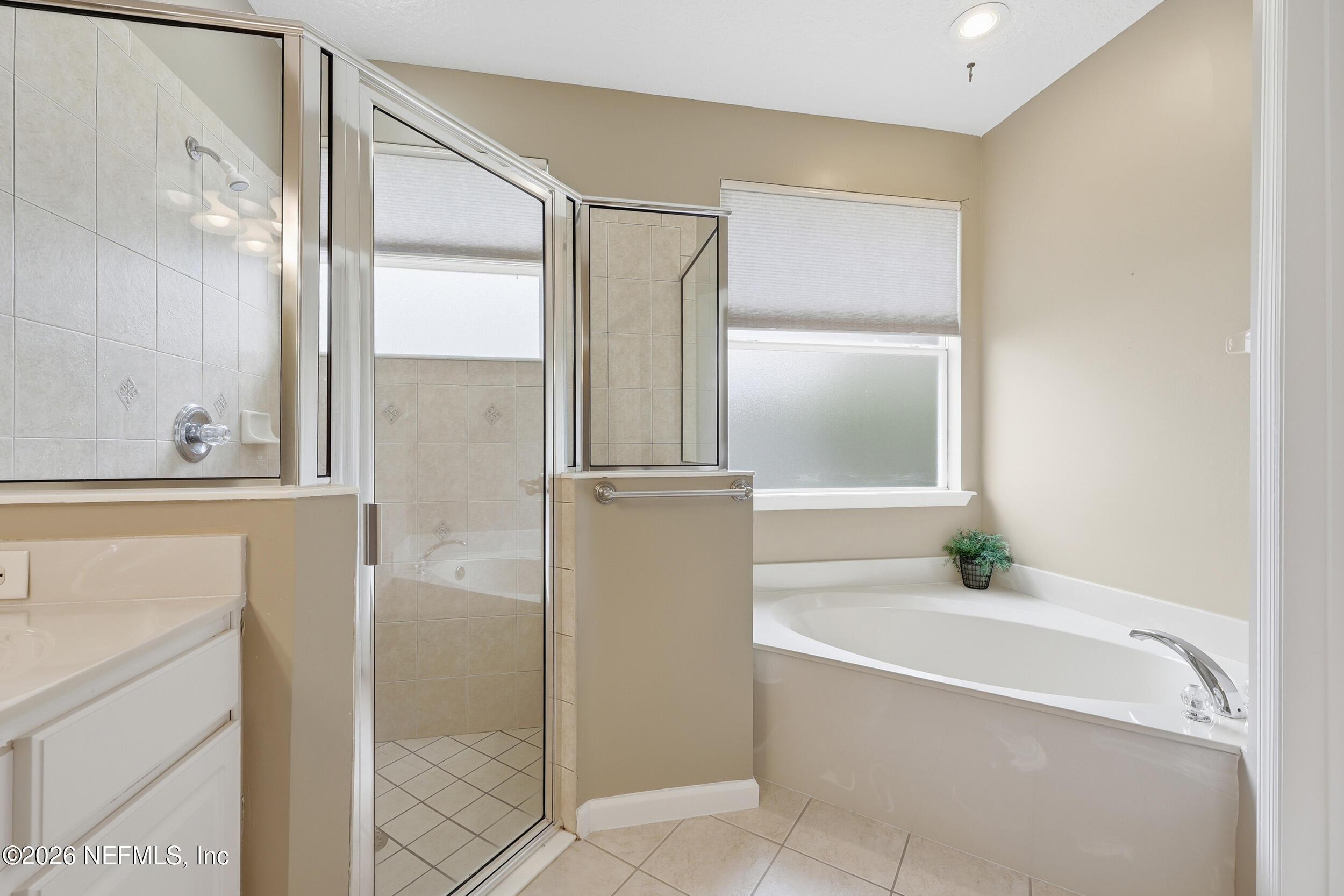 720 Copperhead Circle St. Augustine, FL 32092 - Photo 23 of 65 a bathroom with a bathtub and a shower