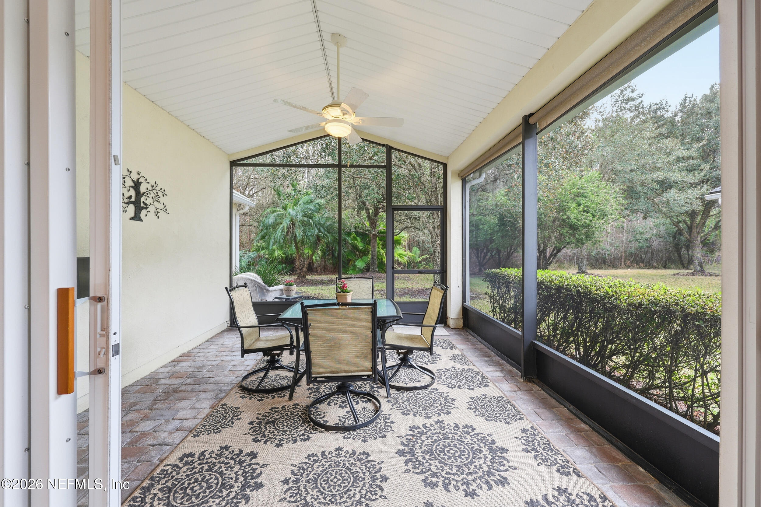 720 Copperhead Circle St. Augustine, FL 32092 - Photo 31 of 65 a dining room with wooden floor and a floor to ceiling window