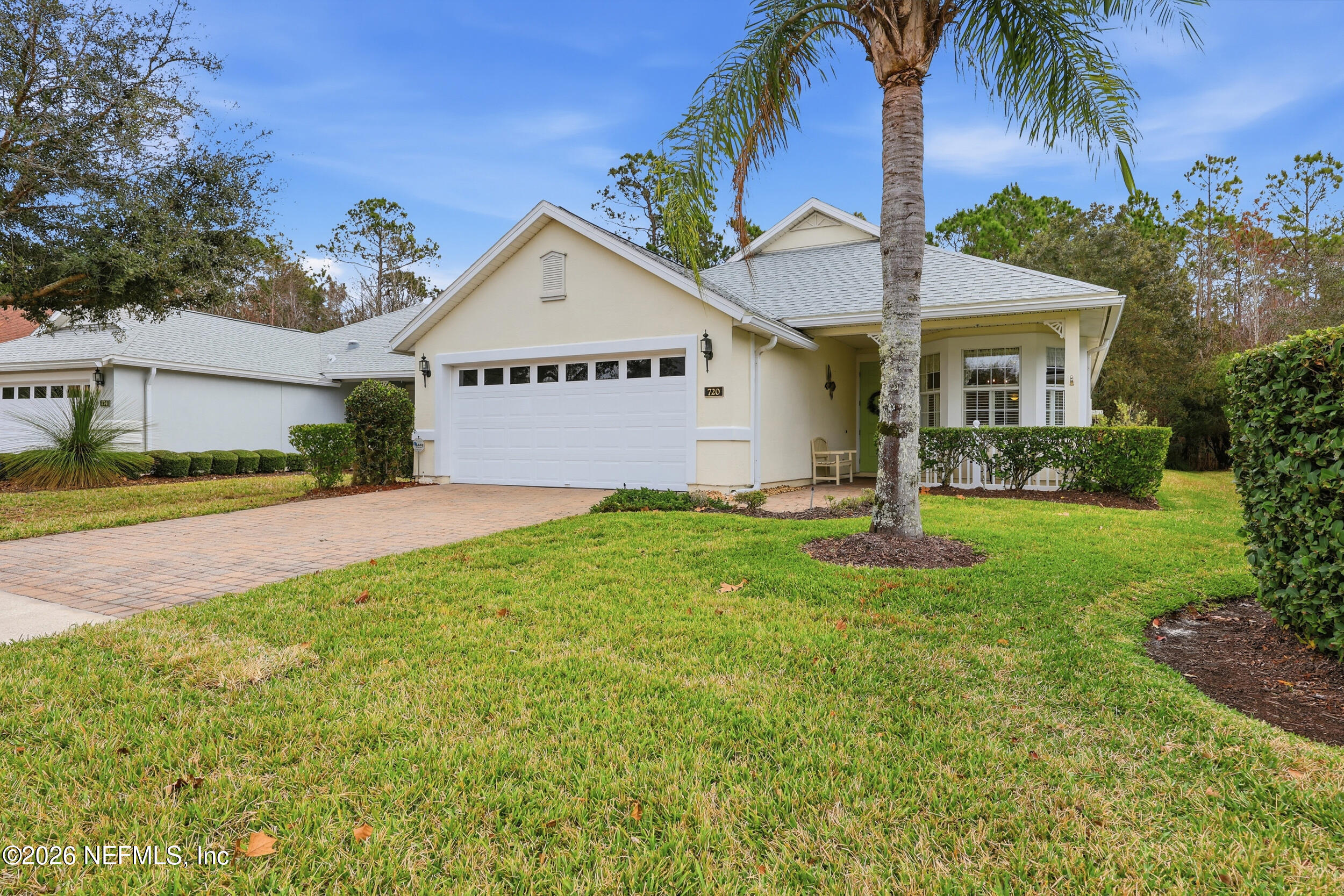 720 Copperhead Circle St. Augustine, FL 32092 - Photo 39 of 65 a view of a white house next to a yard with palm trees
