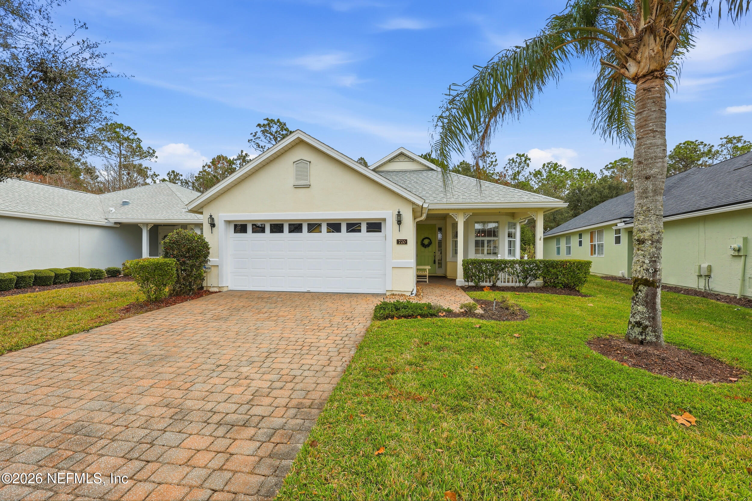 720 Copperhead Circle St. Augustine, FL 32092 - Photo 40 of 65 a front view of a house with a yard and garage
