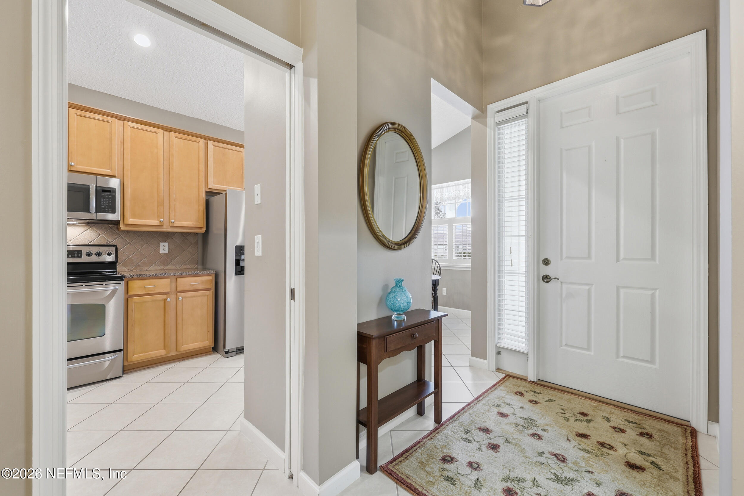 720 Copperhead Circle St. Augustine, FL 32092 - Photo 7 of 65 a view of a kitchen with fridge and wooden floor