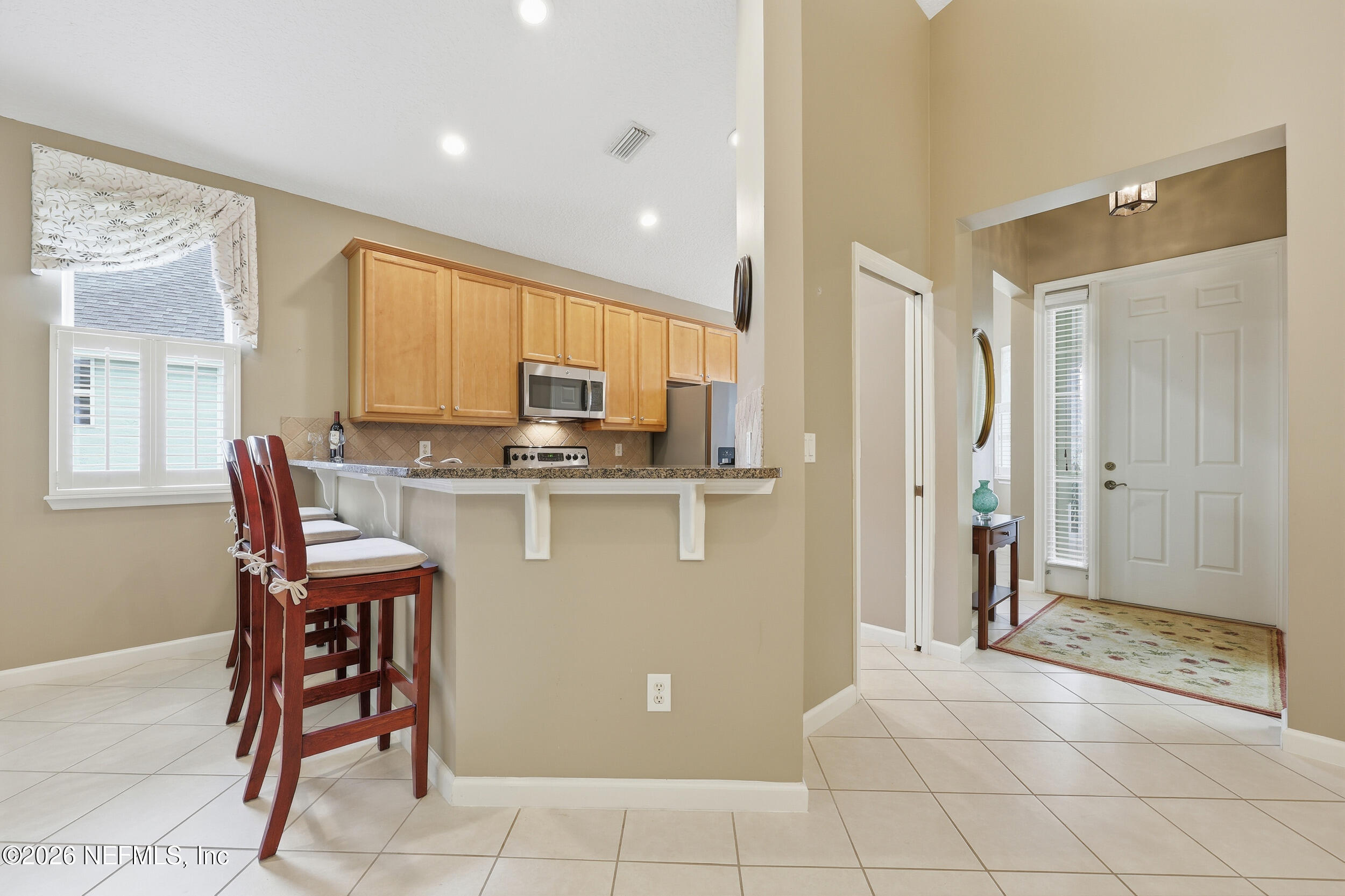 720 Copperhead Circle St. Augustine, FL 32092 - Photo 8 of 65 a kitchen with stainless steel appliances granite countertop a refrigerator and a stove top oven