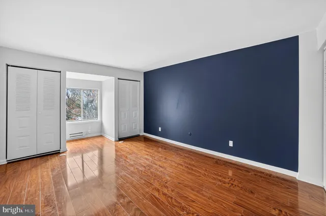 a view of an empty room with wooden floor