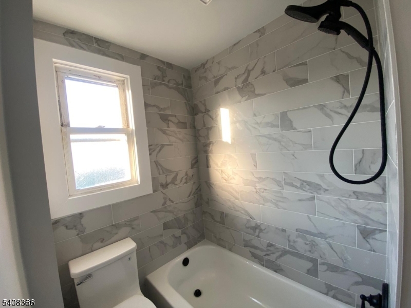 223 John Street Elizabeth, NJ 07202 - Photo 4 of 6 a bathroom with a bath tub and a shower
