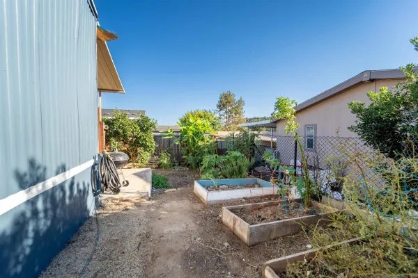 a backyard of a house with outdoor seating