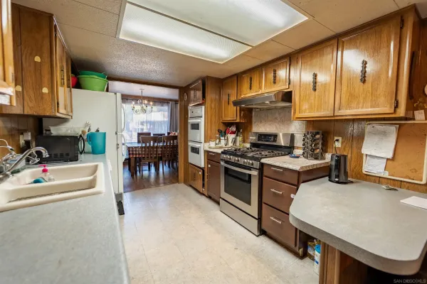 a kitchen with stainless steel appliances granite countertop sink stove and cabinets