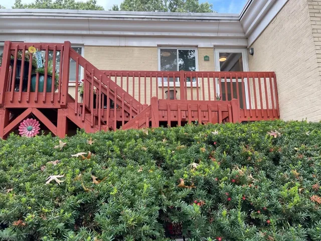 a front view of a building with a yard