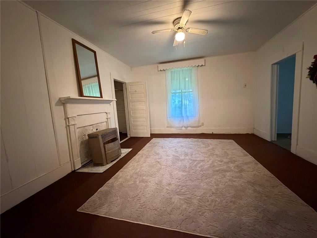 209 Old Perry Road Marshallville, GA 31057 - Photo 18 of 40 a view of empty room with fireplace and fan
