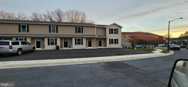 a view of multiple houses with a street