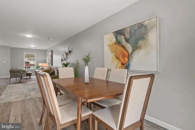 a view of a dining room with furniture and a potted plant