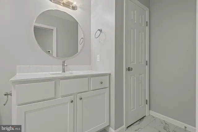 a bathroom with a sink and mirror