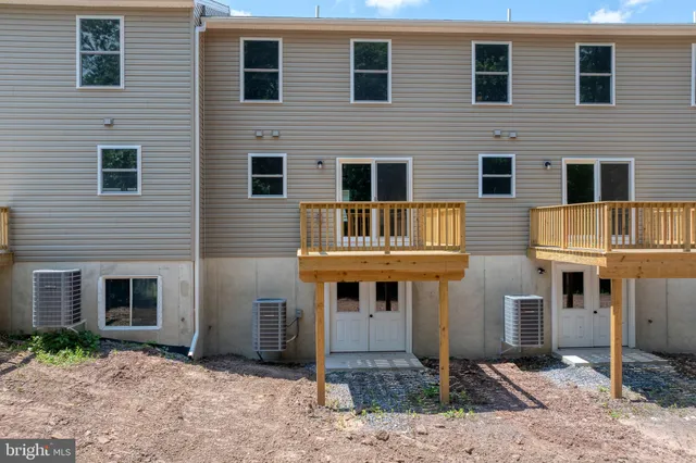 a front view of a house with plants