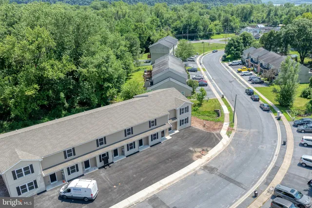 an aerial view of a house with outdoor space and street view