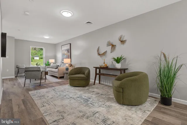a living room with furniture potted plant and a window