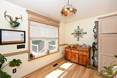 a living room with stainless steel appliances furniture and a large window