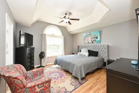 a bedroom with a bed and a chandelier