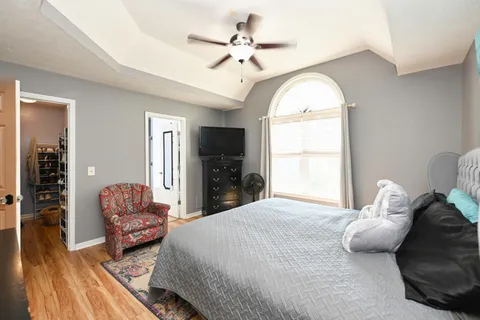 a bedroom with bed and window