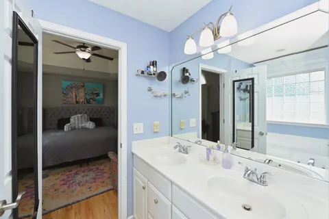 a en suite bathroom with a sink a mirror and a shower